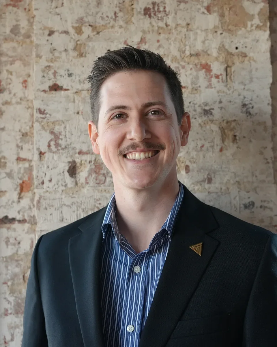 Jack Lilley, founder of Support Serve, smiling in a navy blazer